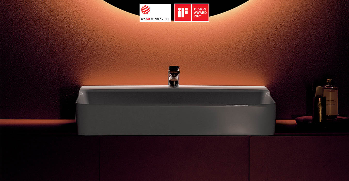 Photo de la collection Conca mise en ambiance montrant une vasque sur meuble suspendu avec un miroir rond au-dessus